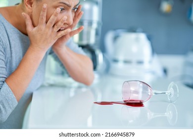 Young Woman And Spilled Wine In The Kitchen