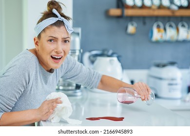 Young Woman And Spilled Wine In The Kitchen