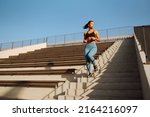 Young woman in sports outfit doing exercises outdoors in the morning. Sport woman doing stretching exercise. Sport, Active life, sports training, healthy lifestyle.