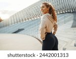 Young woman in sports outfit doing exercises outdoors in the morning. Sport, Active life, sports training, healthy lifestyle.