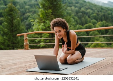 Young Woman In Sportswear Doing Exercise During Yoga Practice Outside