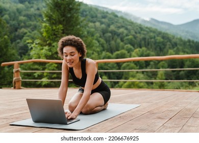 Young Woman In Sportswear Doing Exercise During Yoga Practice Outside