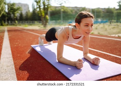 Young woman in sportswear fitness exercise outdoors. Sport, Active life, sports training, healthy lifestyle. - Shutterstock ID 2172331521