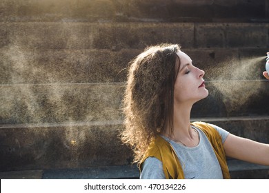 Young Woman Spray Face With Thermal Water. Enjoying, Skin Care Concept.