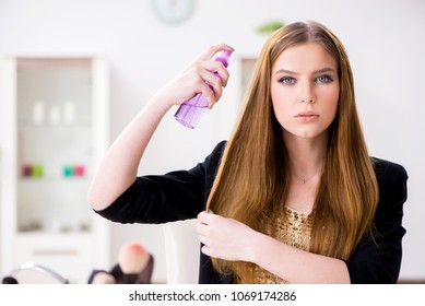 Young Woman Spraying Hair Polish To Her Hair