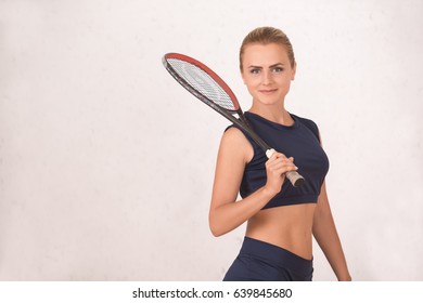 Young woman squash player exercise game in the gym