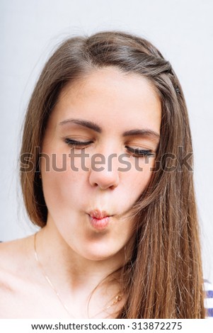 Young woman squeezing cheeks