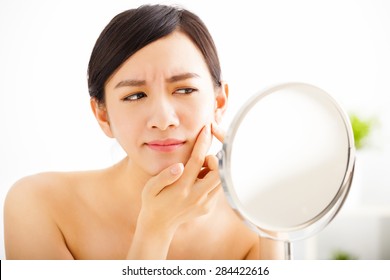  Young Woman Squeezing Pimple Looking On Mirror