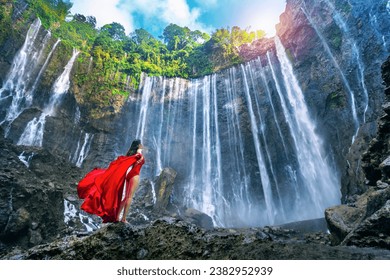 Young woman standing at Air Tumpak Sewu Waterfall, Indonesia. - Powered by Shutterstock