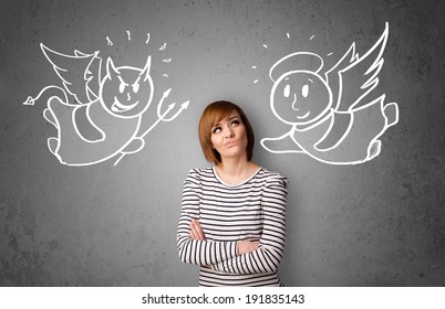 Young woman standing between the angel and the devil drawings
