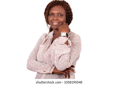 Young Woman Standing In Flowery Shirt, Hand Under Cheek Looks At Camera Smiling.