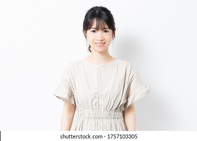 Young woman standing in front of white background