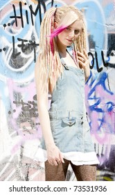 Young Woman Standing At Graffitti Wall