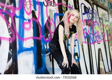 Young Woman Standing At Graffitti Wall