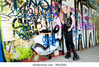 Young Woman Standing At Graffitti Wall