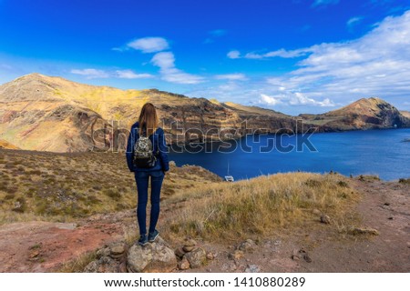 Young woman standing and looking in Cabo Sao Lourenco, beautiful cape of Madeira, Portugal