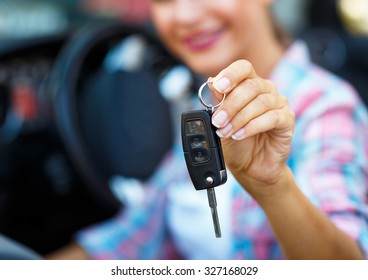 Young Woman Standing Near A Convertible With Keys In Hand - Concept Of Buying A Used Car Or A Rental Car