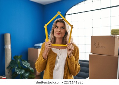Young woman standing at new home smiling looking to the side and staring away thinking.  - Shutterstock ID 2271141385