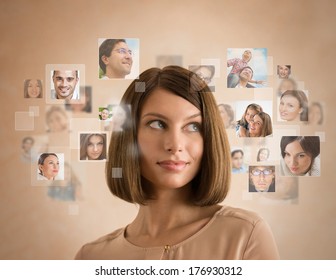 Young Woman Standing And Smiling With Many Different People's Faces Around Her. Technology Social Media Network Of Friends And Communication.