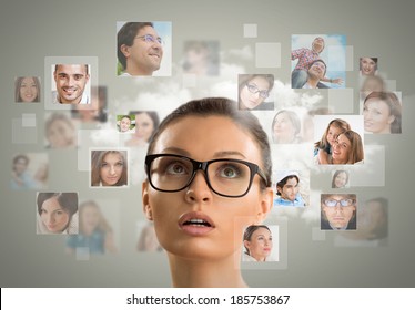 Young Woman Standing And Smiling With Many Different People's Faces Around Her. Technology Social Media Network Of Friends And Communication.