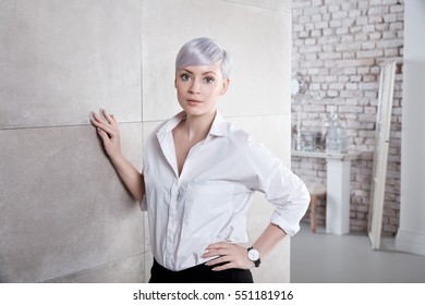 Young Woman Standing At Trendy Home, Looking At Camera.