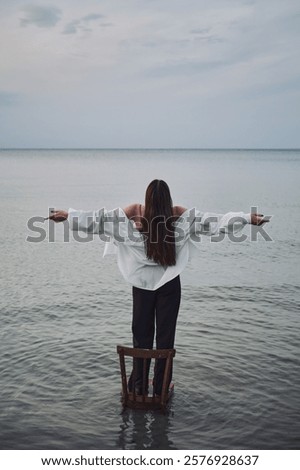 Similar – Image, Stock Photo Woman standing in shallow water with bare legs talking to her dog