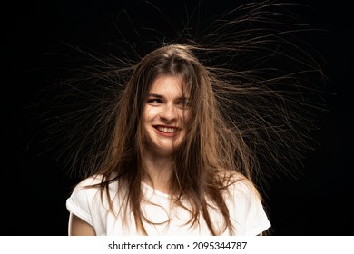 Young Woman With Static Hair, On Black Background. 