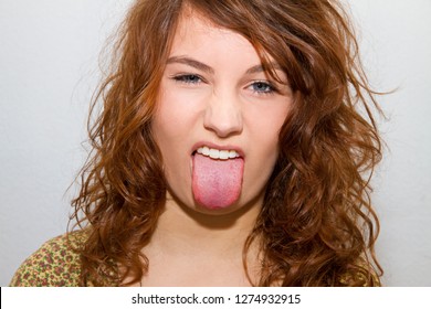 Young woman sticking tongue out