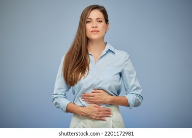 Young woman with stomach pain. isolated portrait on blue. - Shutterstock ID 2201172981