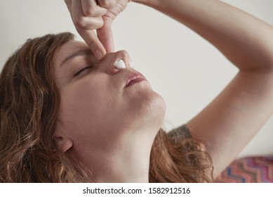 Young Woman Stop Nose Blood With Cotton Wool Swabs. Woman Suffer From Nose Bleeding