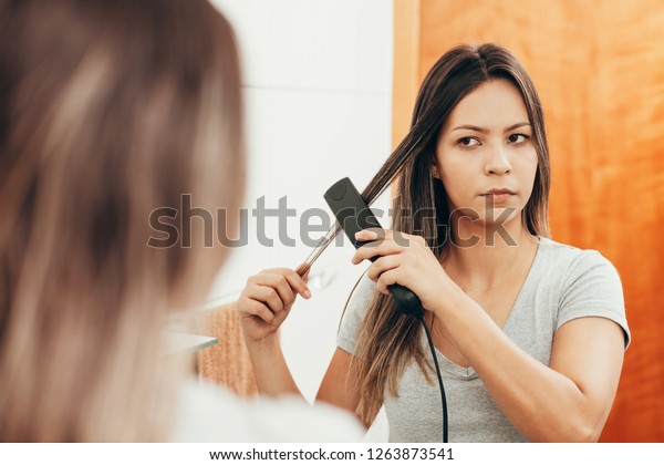 Young Woman Straightening Hair Hair Straightener Stock Photo Edit