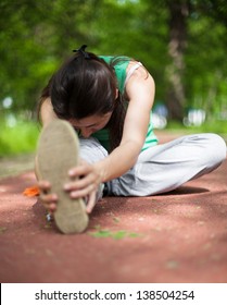 Young Woman Streching In The Park