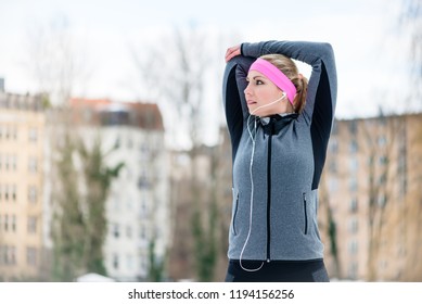 Young Woman Stretching During Sport Training Outdoor On A Winter Day