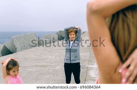 Similar – Two women walking by sea pier