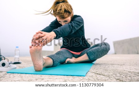 Image, Stock Photo Young woman stretching legs by sea pier