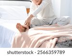 young woman stretching on bed