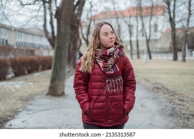 Young Woman Student With Down Syndrome Walking In Street In Winter