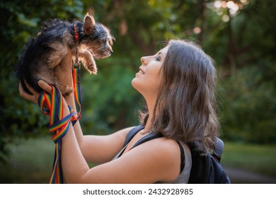 A young woman, a student, holds a small dog. Love for pets. Yorkshire terrier puppy. - Powered by Shutterstock