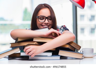 Young Woman Student With Many Books