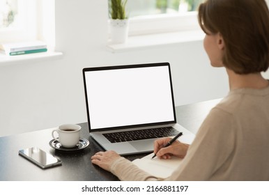 Young Woman Studying At Home, Blank White Screen Display Mockup. Student Girl Using Laptop Computer. Online Shopping, Web Site, Working From Home, Online Learning, Studying Concept.