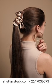 Young Woman With Stylish Bandana On Beige Background