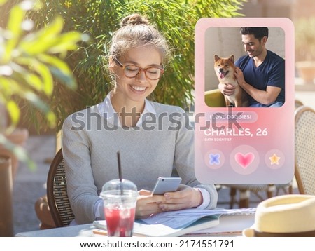 Young woman in stylish specs using dating app on mobile phone sitting in cafe outdoors, liking profile of handsome guy with dog, enjoying summer morning. Modern virtual relationships