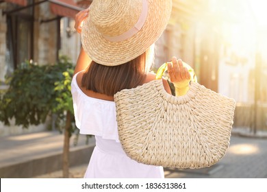 Young Woman With Stylish Straw Bag Outdoors