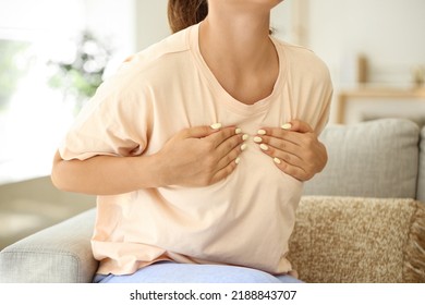 Young Woman Suffering From Breast Pain At Home, Closeup