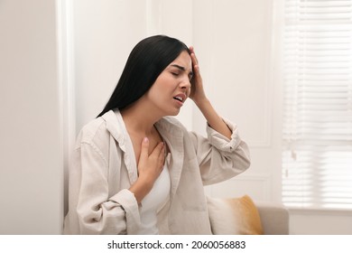 Young woman suffering from breathing problem at home - Powered by Shutterstock