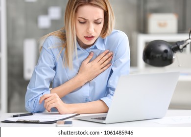 Young Woman Suffering From Chest Pain In Office