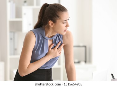 Young Woman Suffering From Heart Attack In Office