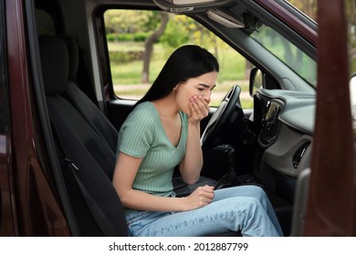 Young Woman Suffering From Nausea In Car