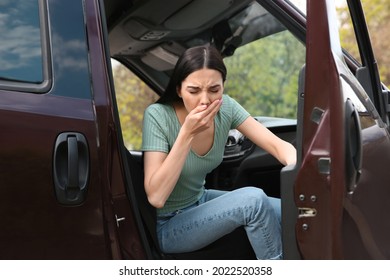 Young Woman Suffering From Nausea In Car