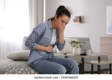 Young woman suffering from nausea at home. Food poisoning